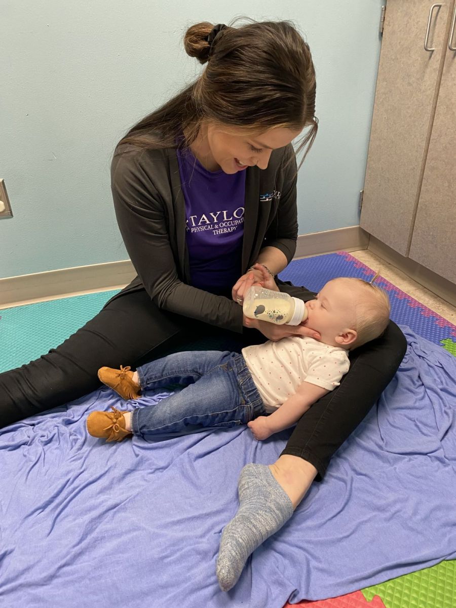 Image of Taylor Physical Therapy's therapist with a peds patient Physical Therapist Kristen Kahler